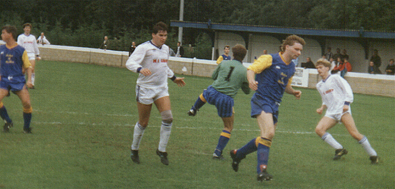 Ronnie Murrock is beaten to the ball by the Egham keeper, Andy Sawyer is on the right.