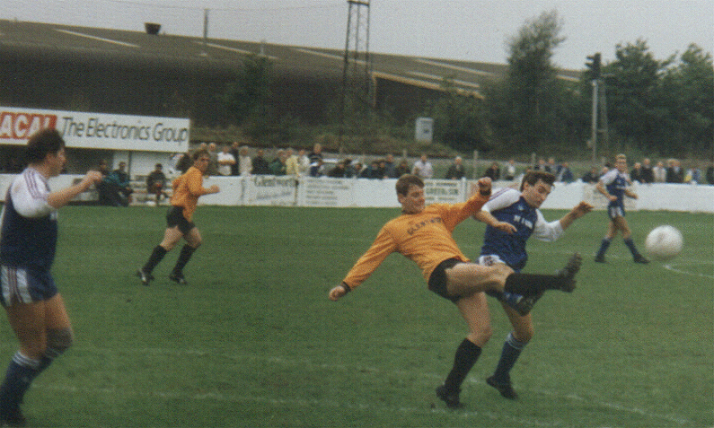A Margate player goes up for a high ball as Ronnie Murrock watches.