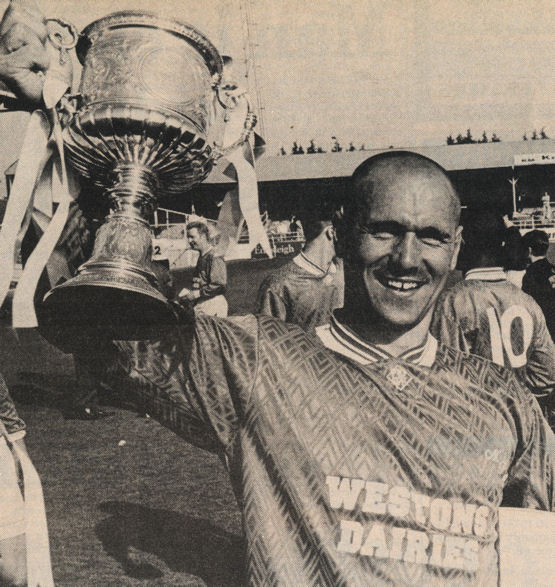 Joe Brayne, scorer of the winning goal, shows off the cup. Paul Malcolm is Margate's number 10 and Billy Plews is in the background.