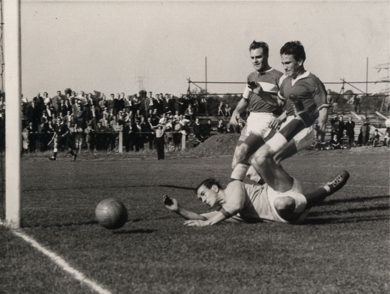Brian Hughes watches a Canterbury shot go past his post with Terry Joyce looking on.