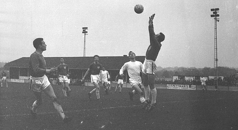 Alan Blackburn watches as the visiting keeper goes up to catch the ball.