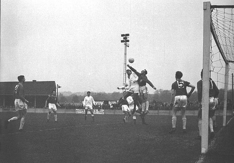 Alan Jones challenges the keeper with David Hills looking on