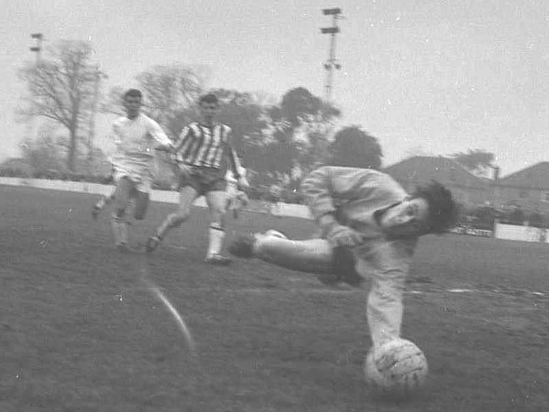 The Rams keeper saves as David Hills runs in.