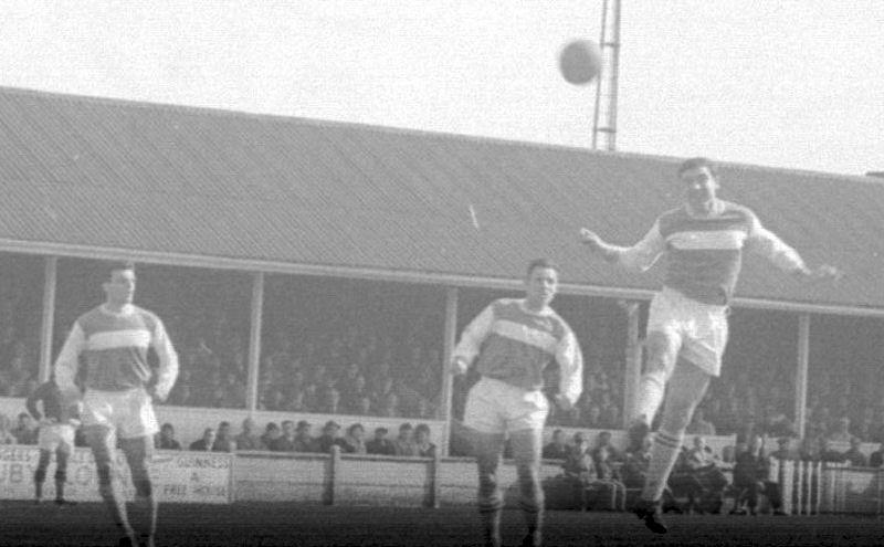 Bob Harrop climbs to head the ball as Cyril Jeans (left) and Alan Blackburn (centre) look on.
