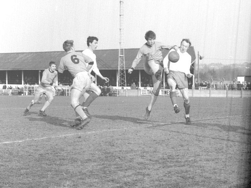 Don Campbell attempts to block a Burton attacker with Derek Grace looking on.