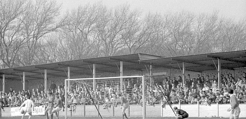 The referee (right) crouches for a good view of the action.