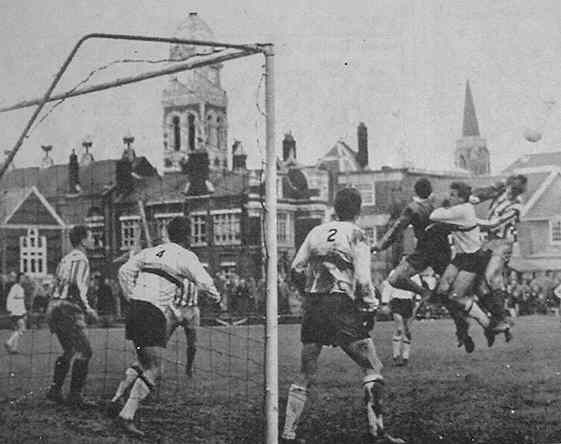 The Eastbourne keeper punches clear from John Fahy.