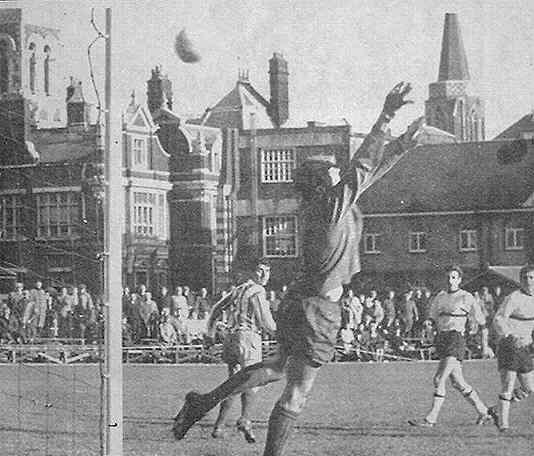 Derek Grace's shot flies into the net as Phil Amato watches.