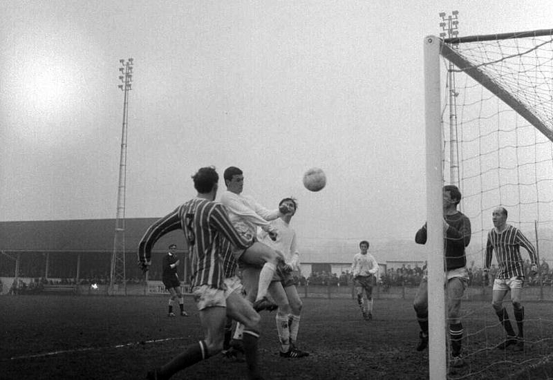 Derek Grace heads at goal.