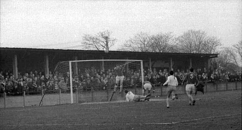 The Hillingdon keeper punches clear from John Fahy (on the ground) as Phil Amato (7) closes in.