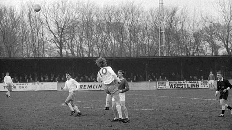 Tommy Jenkins heads the ball on as Terry Morris watches.