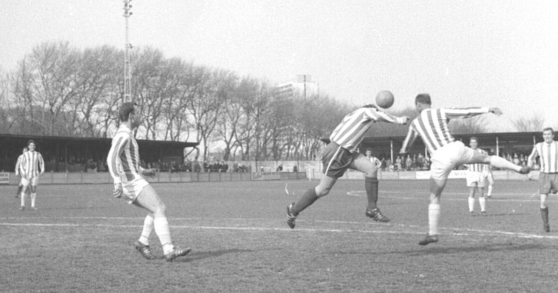 Dennis Randall challenges as Bryan Clifton (right) looks on.