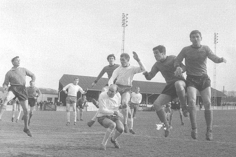 Tommy Marshall clatters into Laurie Thomson as Dennis Randall (left) and Harry Hughes (right) look on.
