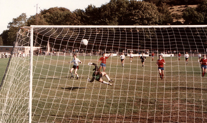 A shot from Richard Hemmings is about to hit the bar to deny Thanet (in red) a goal. The despairing Dover goalkeeper is Joe Radford.
